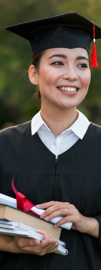 women wearing graduation gown and holding degree & books as well